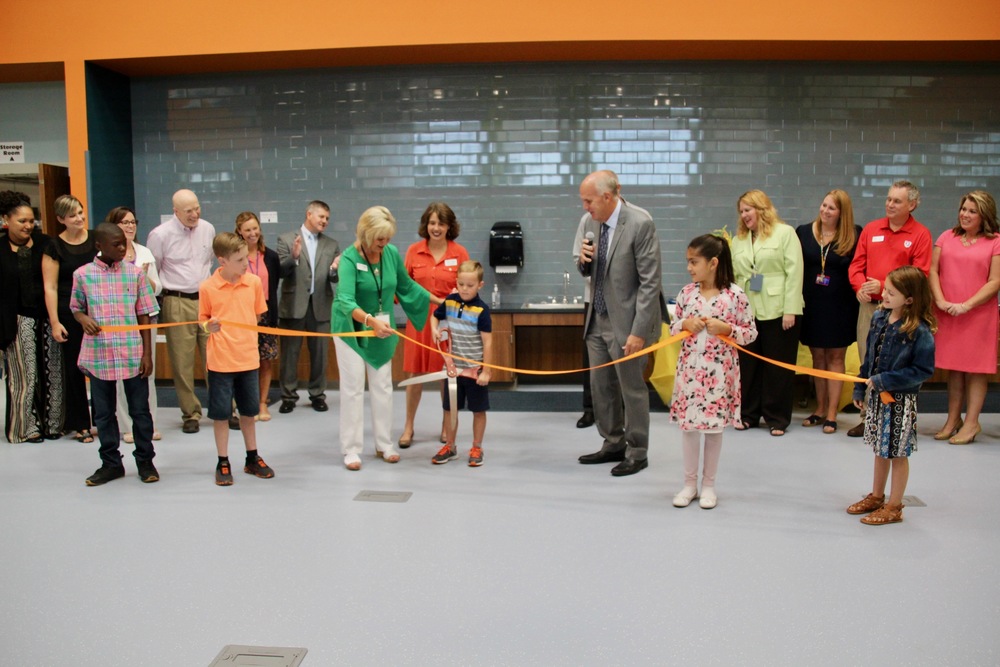 Surrounded by Plainfield Schools administrators and board members, elementary students cut the ribbon to celebrate the opening of The Imagination Lab