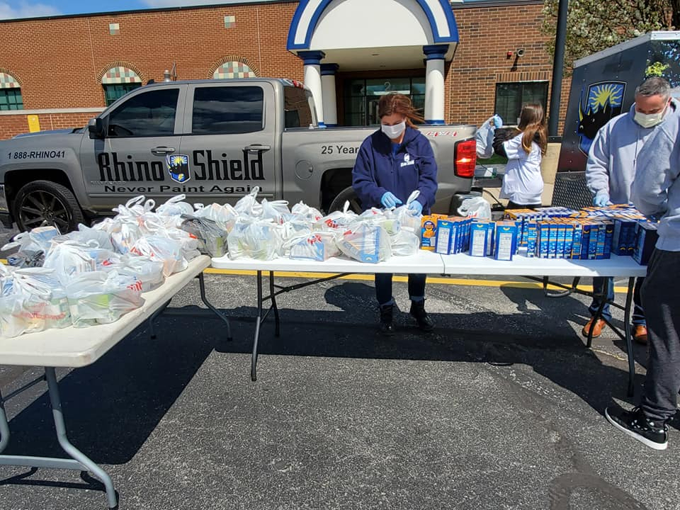 RhinoShield employees prepare to distribute 100 Easter meals to Plainfield families