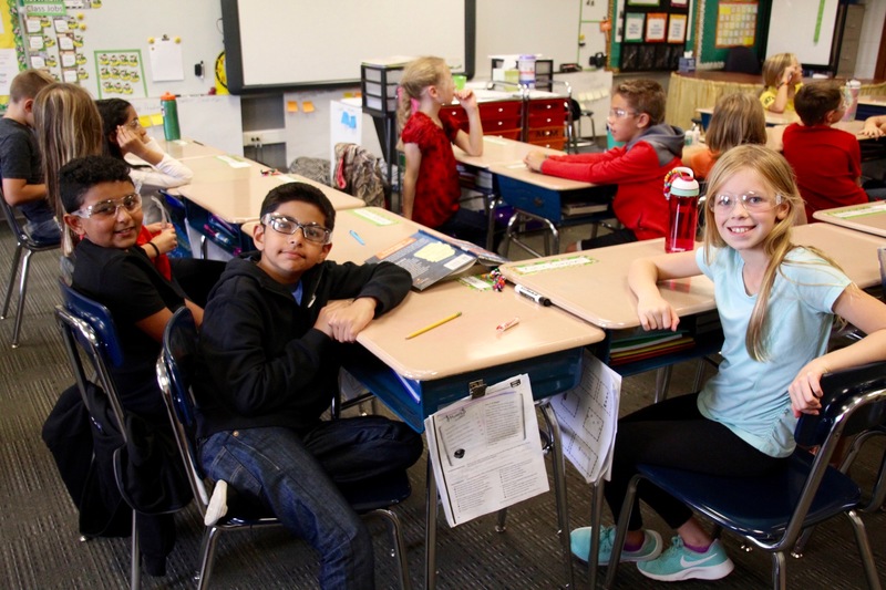 Prepared with safety goggles, these 4th graders are ready for their next experiment.