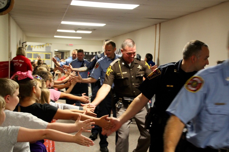 Local police, who serve in many capacities, brought smiles to student's faces as they eagerly gave high fives.