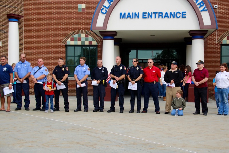 At dismissal, students from each class lined the front sidewalk with flags, while everyone left in silence.