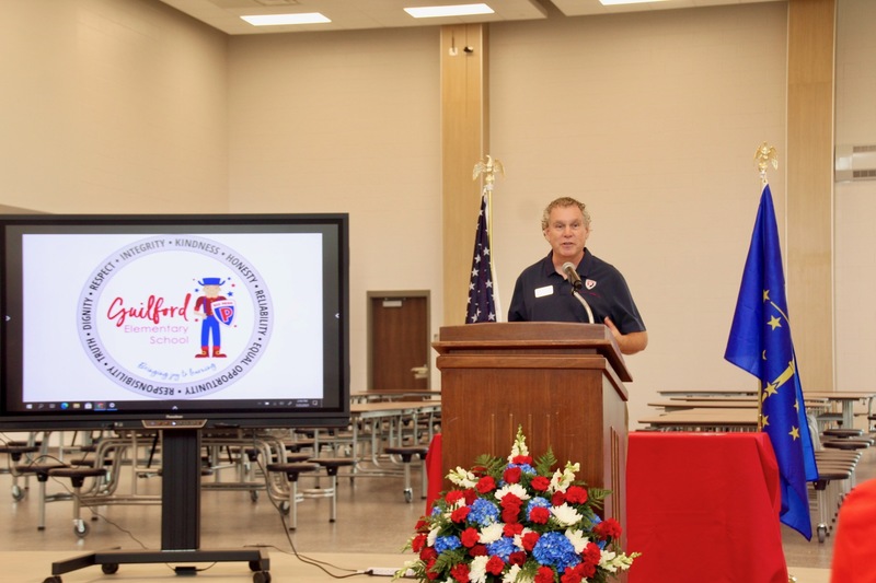 School Board President Scott Flood speaks to guests during the Guilford Elementary School ribbon-cutting ceremony