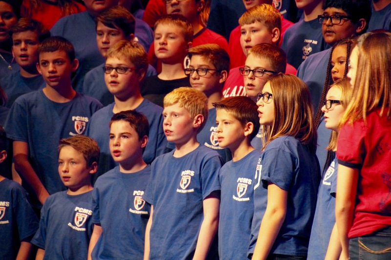 The 7th grade choirs came together to perform several patriotic songs, included a sing-along version of "God Bless America."