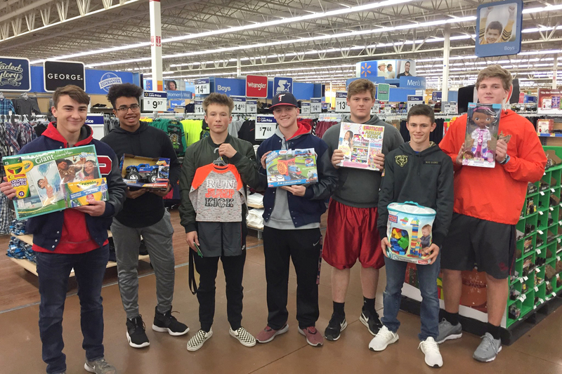 PHS football players provided Christmas for a family this year, and the boys pictured here enjoyed shopping for toys.