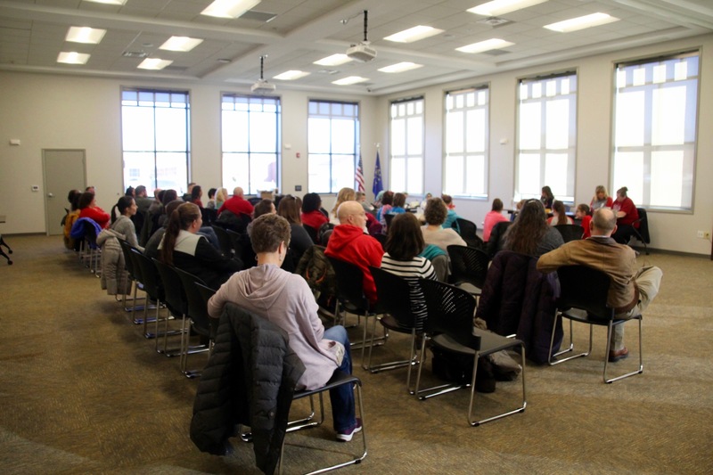 The board room was filled with family members, principals and friends.