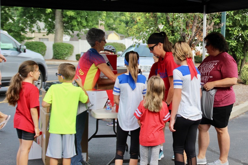 Students receiving their helmets from GearUp Cyclery