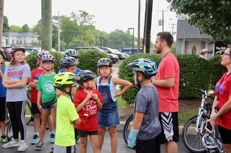 Mr. Wheeler explaining the gift of bicycles to his students