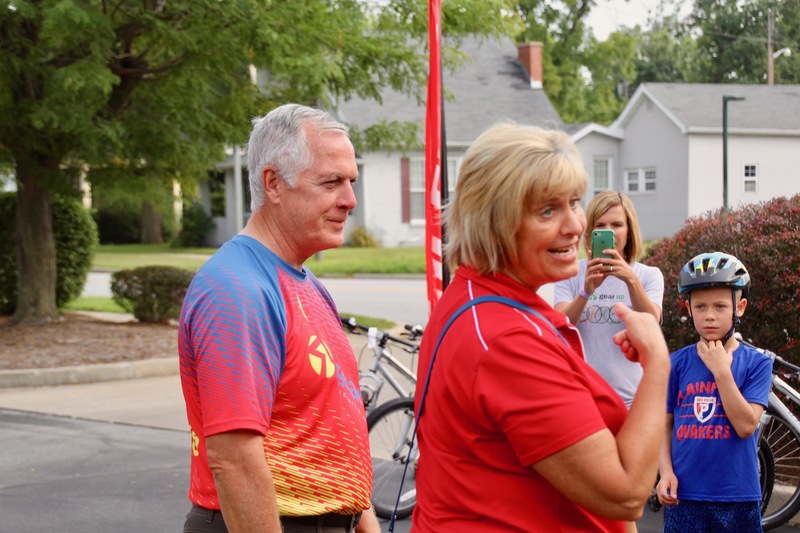 Dr. Mary Giesting, Director of The Imagination Lab, thanks Dennis Gibbs and his family for their donation of bicycle and helmets, on behalf of GearUp Cyclery, to Central Elementary