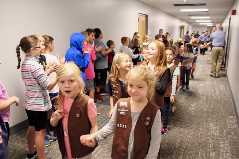Elementary members of the Boy and Girl Scouts led their special guests on the parade through their schools.