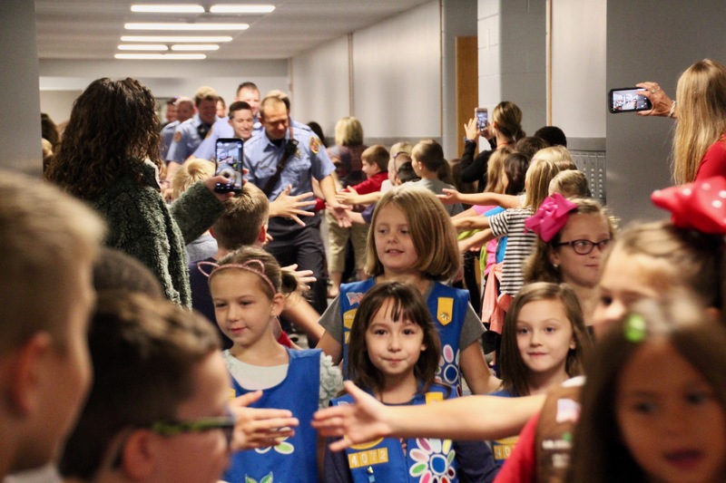 Elementary members of the Boy and Girl Scouts led their special guests on the parade through their schools.