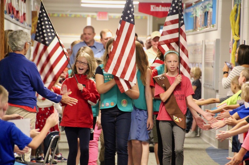 Elementary members of the Boy and Girl Scouts led their special guests on the parade through their schools.