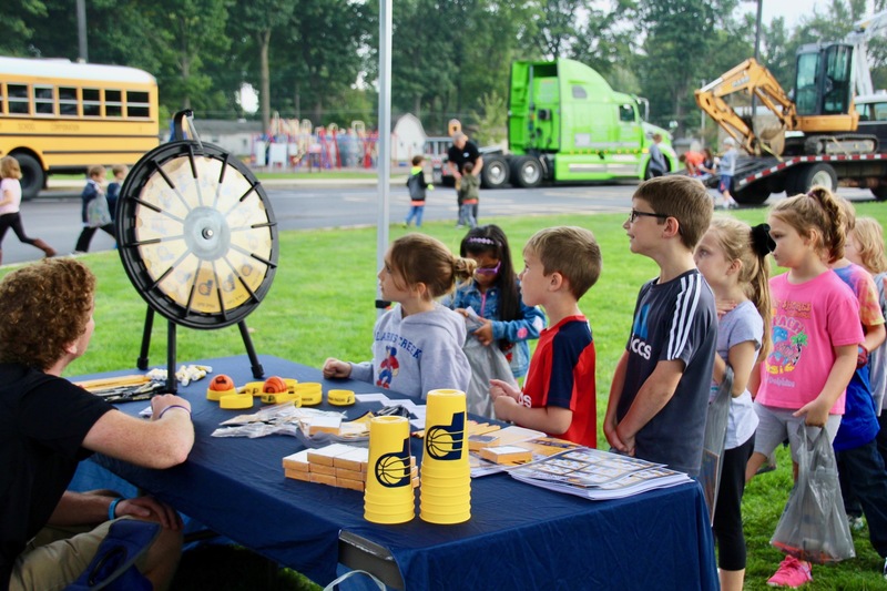 First grade students from Brentwood and Clarks Creek spin the Pacers' wheel on Transportation Day 